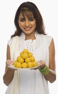 Woman with plate of ladoos